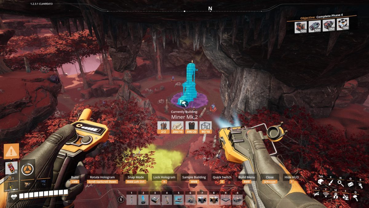 Building a Miner Mk.2 hologram on a resource node in a red cavern in Satisfactory