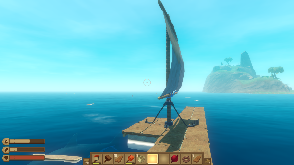 A sail raised on the raft catching the wind with an island on the horizon in Raft